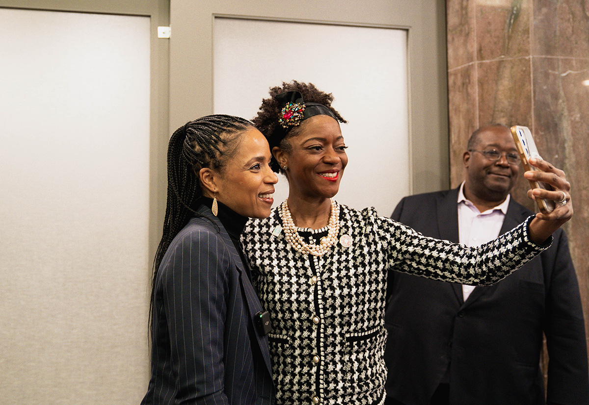 Nichelle Gainey taking selfie with attendee at Senate launch