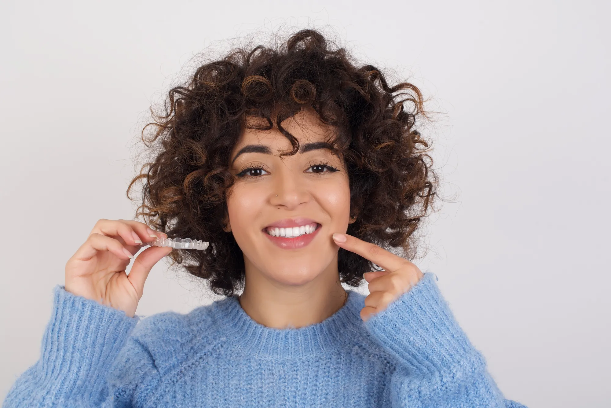 Patient smiling with Invisalign clear aligners in Matthews, NC