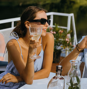 Person in blue shirt marking a location on a city map with a blue pen.