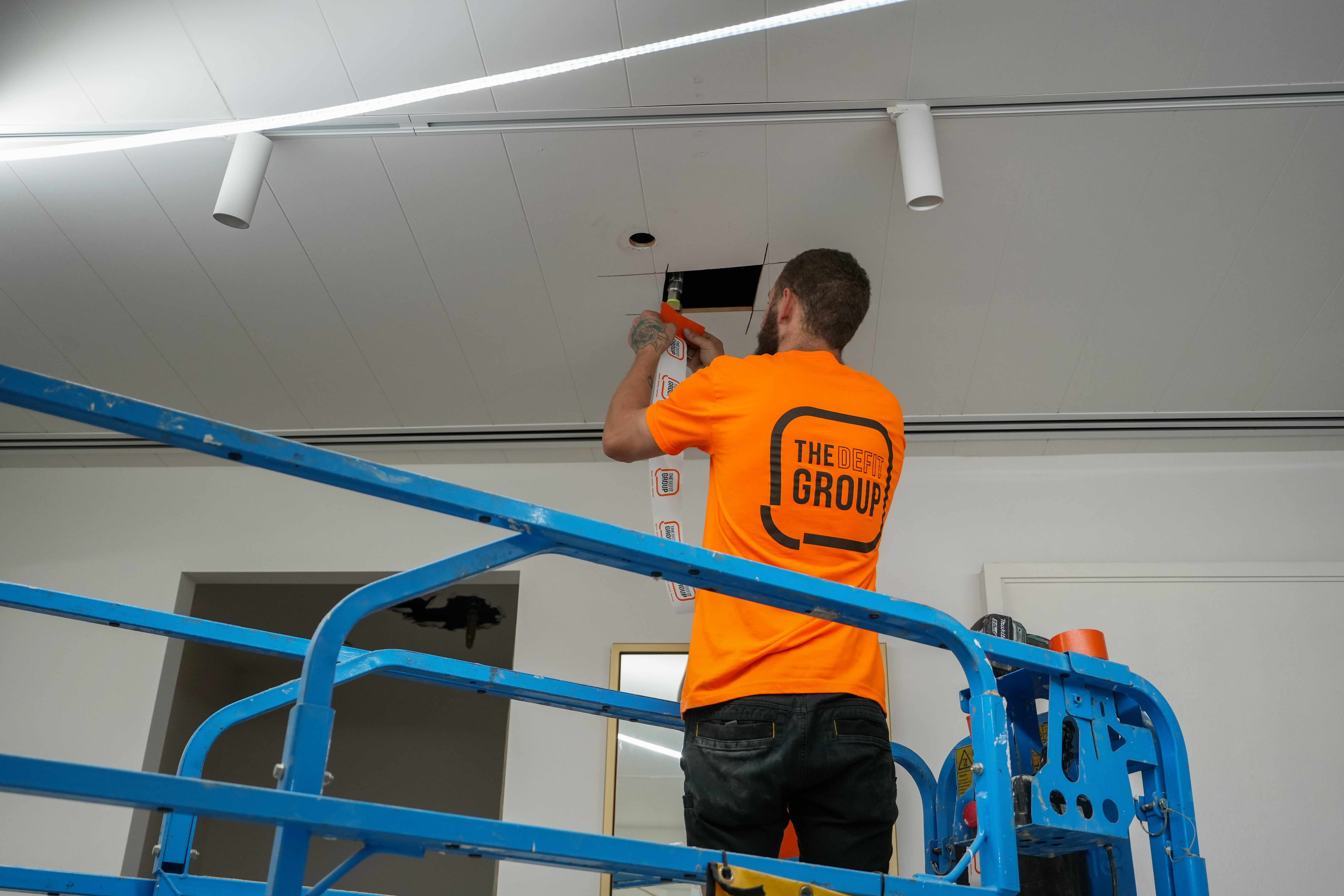 Indoor concrete staircases with glass panel railings in an unfinished building under construction.