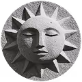 Stone carving of a serene sun face with closed eyes and surrounding rays.