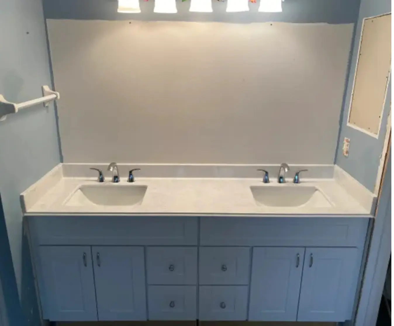 Double sink bathroom vanity with new faucets installed by a professional plumber in Thousand Oaks, CA