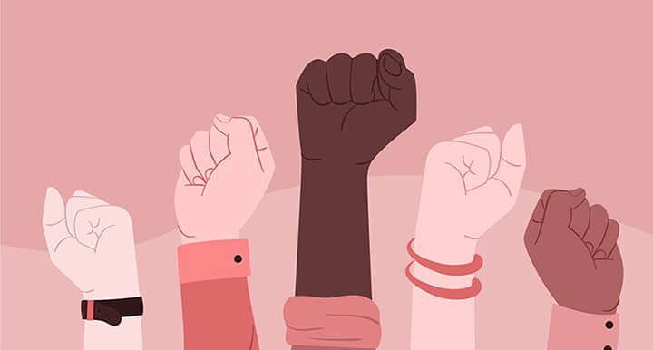 Illustration de cinq poings levés de différentes couleurs de peau symbolisant la diversité et la solidarité.