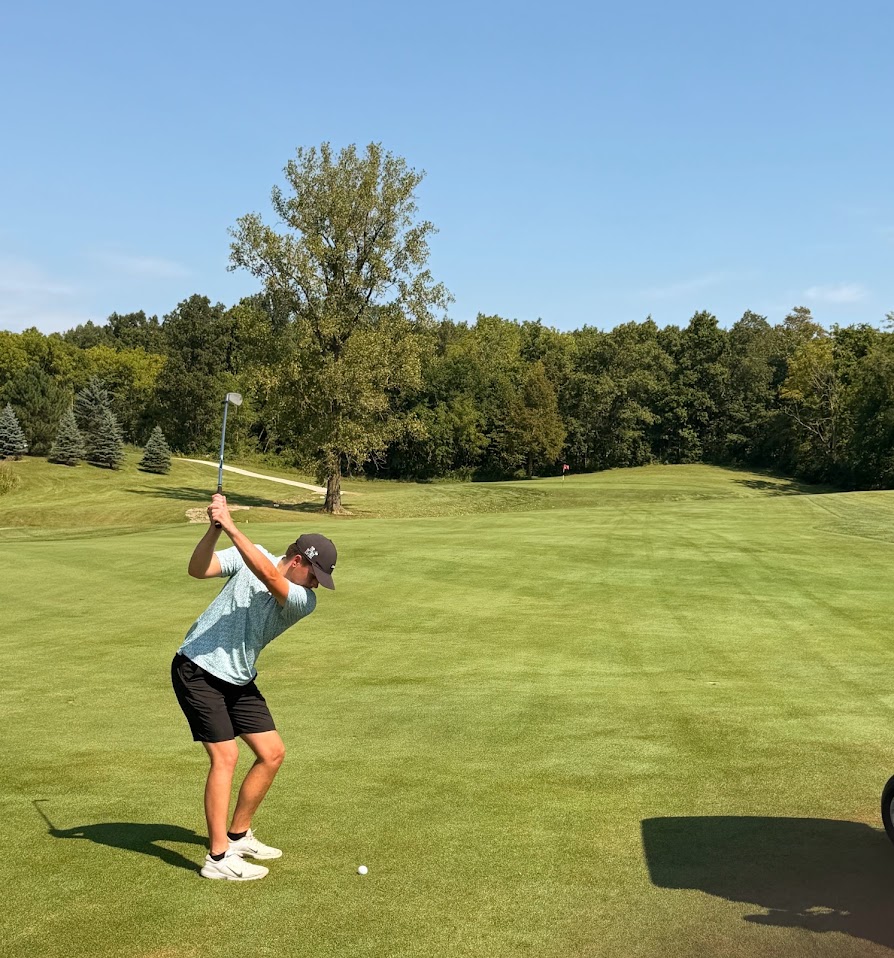 Golfer teeing off near Indian Lake, Ohio
