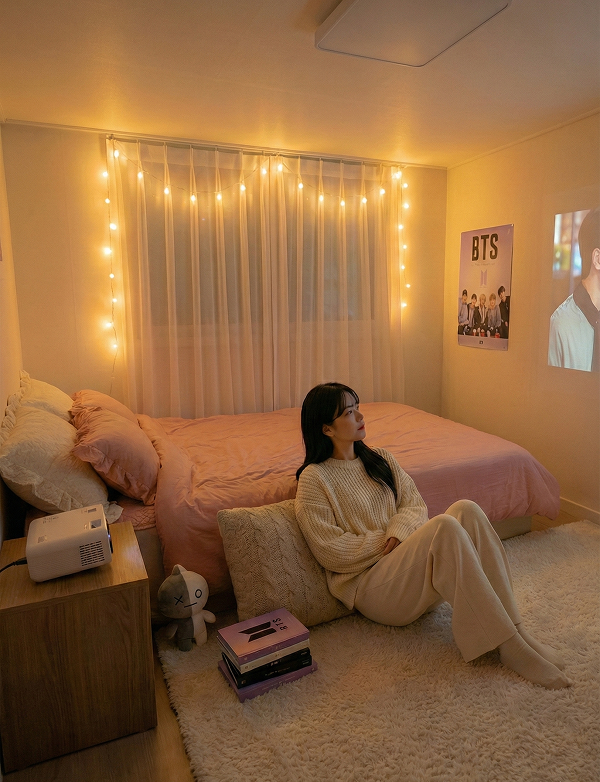 Cozy Korean style bedroom with floor cushions and a home cinema projector setup.