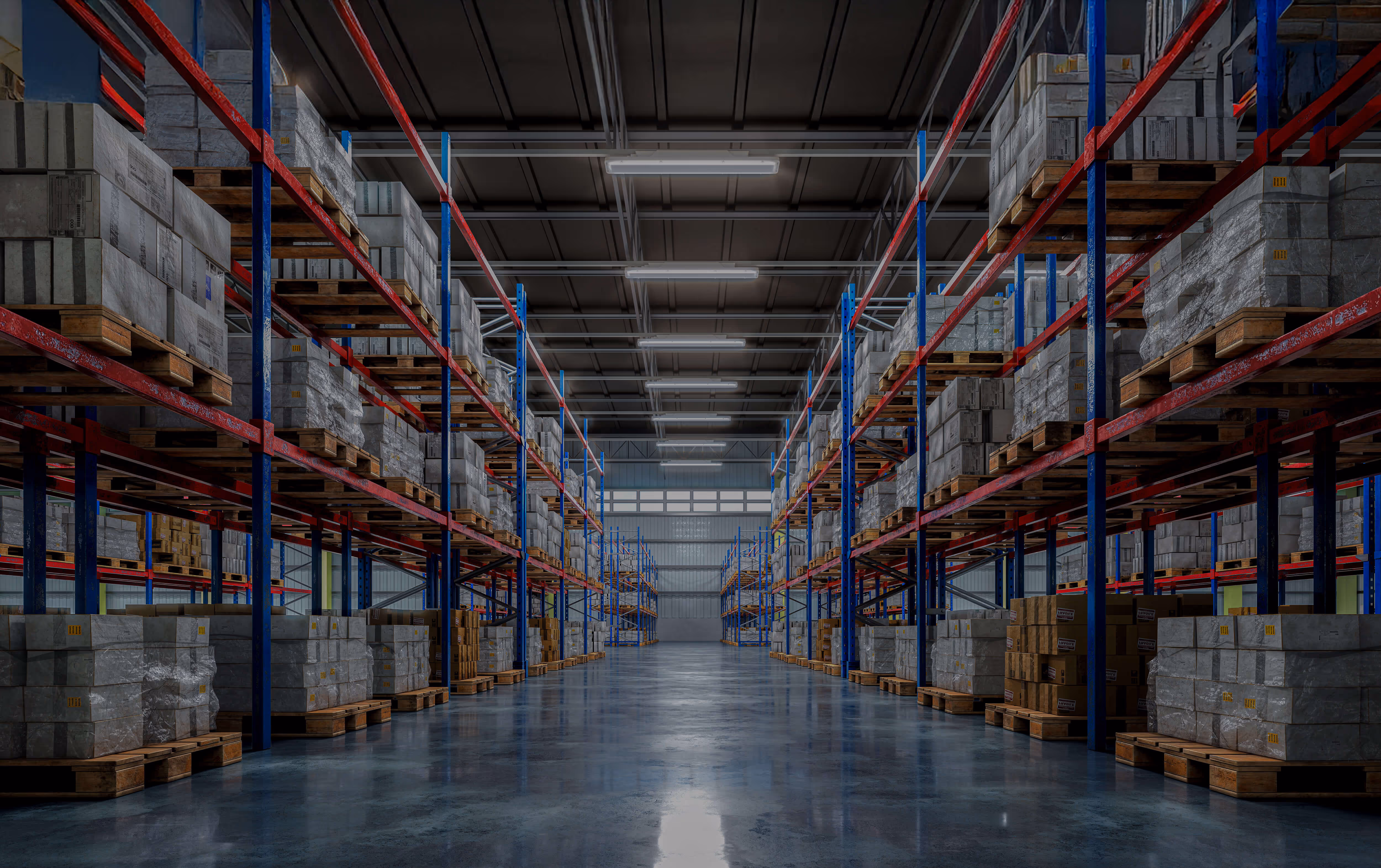 Spacious warehouse aisle with tall metal racks filled with stacked cardboard boxes on wooden pallets.