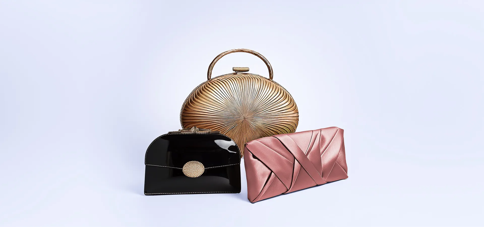 A black and pink purse is on a white background.