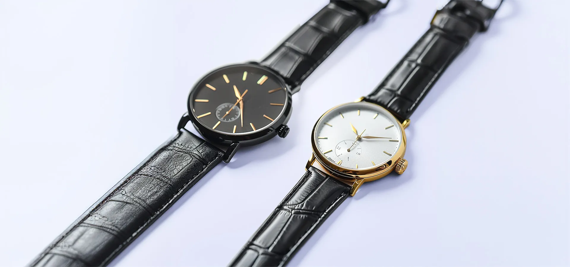 A black and gold watch is on a black strap.
