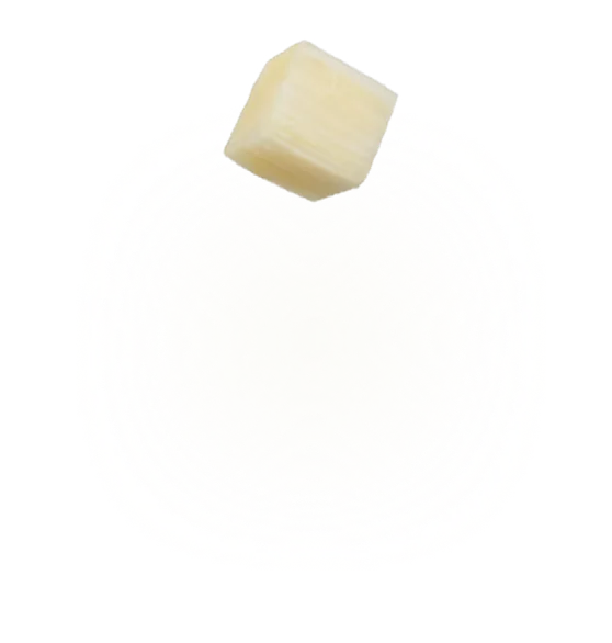 Single cube of diced coconut with light beige color isolated on white background.