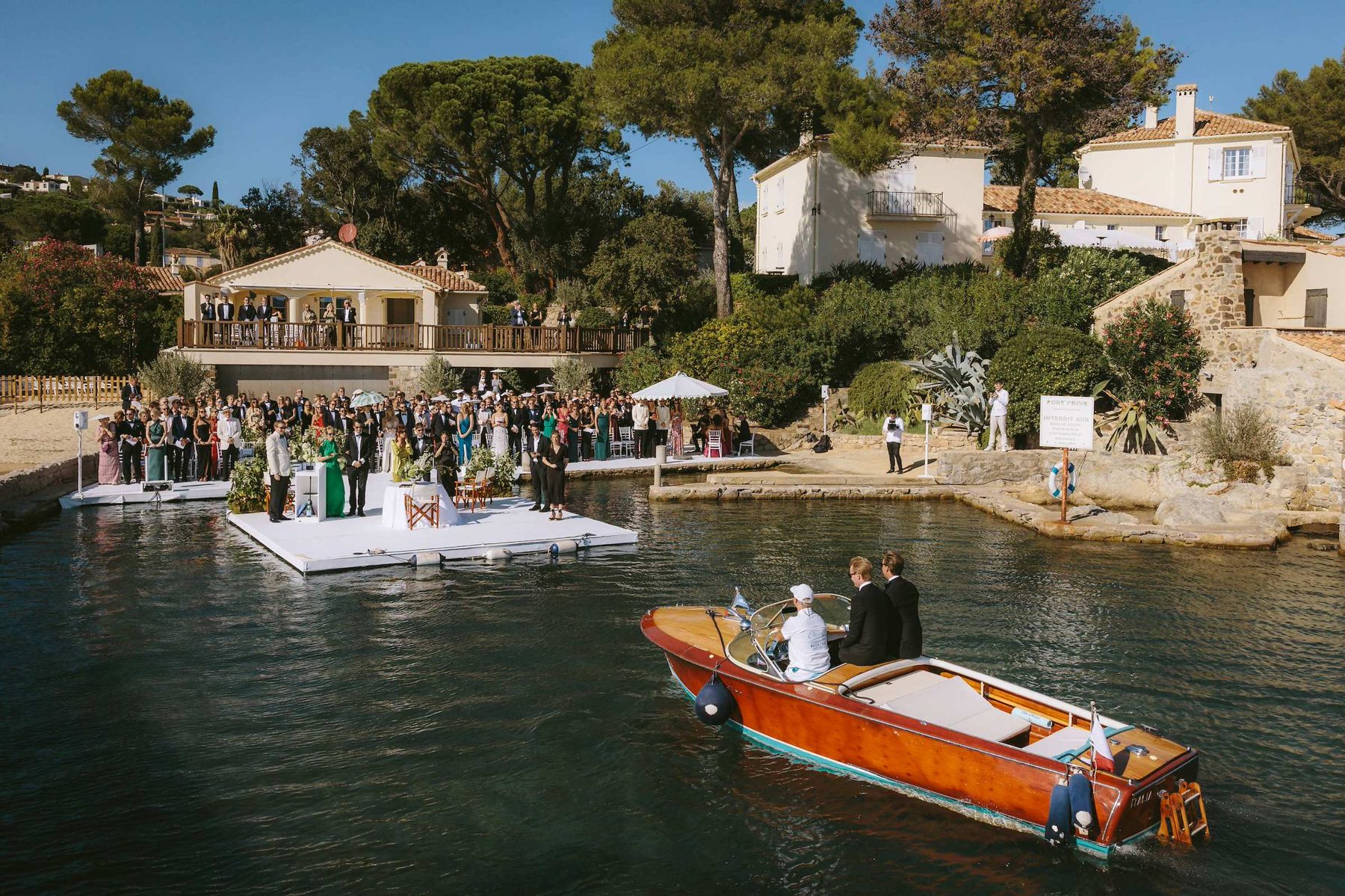 Bride arriving by boat at the private harbour of Villa Odyssee