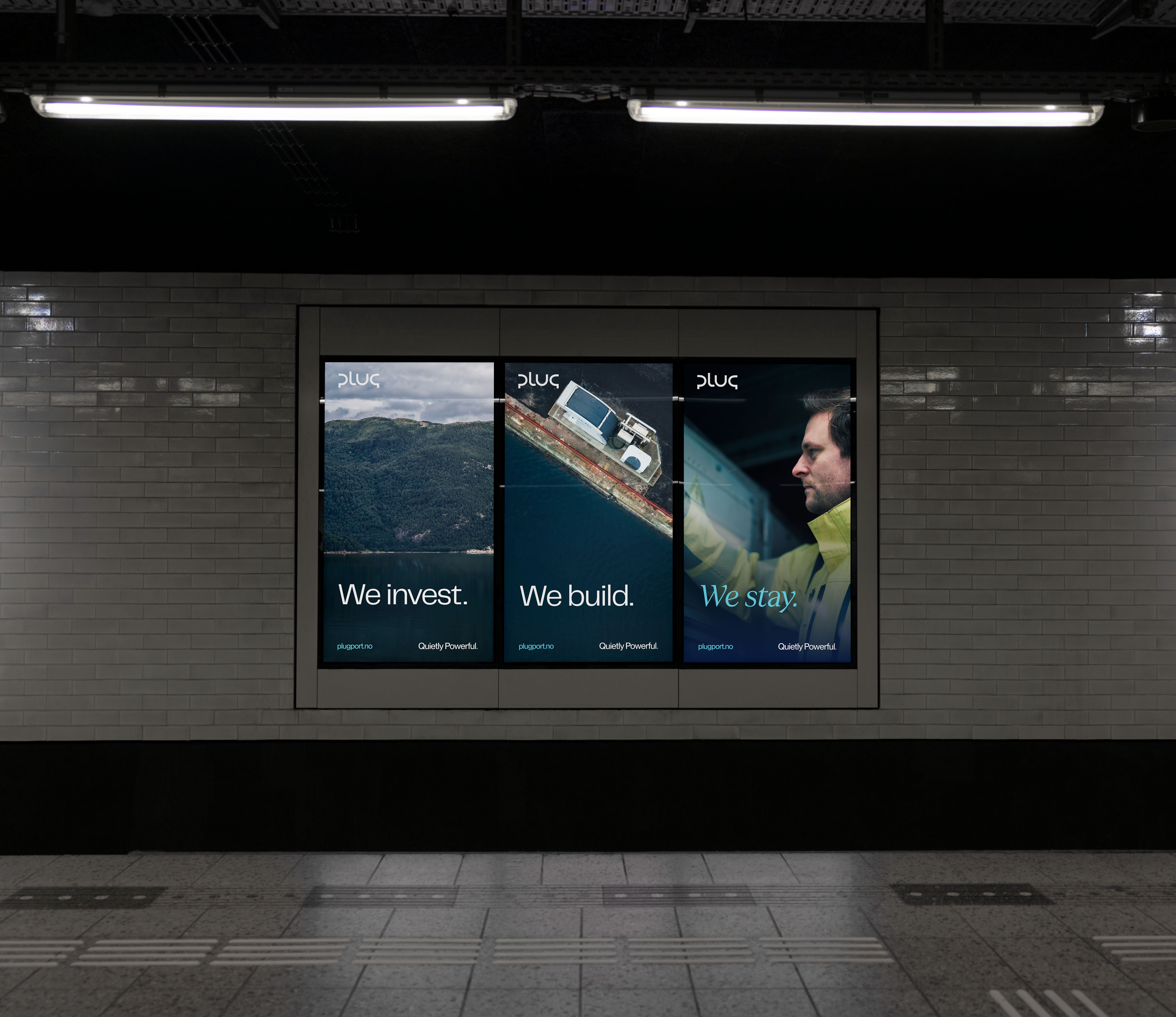 Three digital advertisements in a subway station showing nature, a docked ship, and a man in a yellow jacket with text: We invest. We build. We stay.