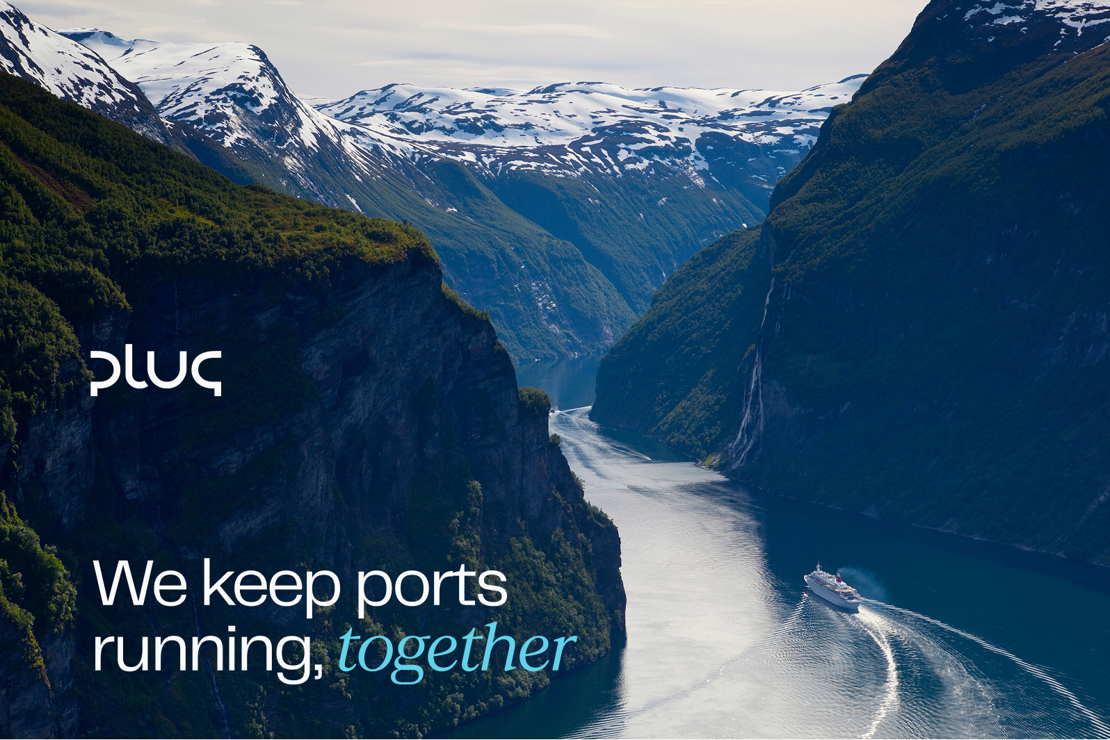Cruise ship sailing through a narrow fjord surrounded by steep, green mountains and snow-capped peaks in the background.