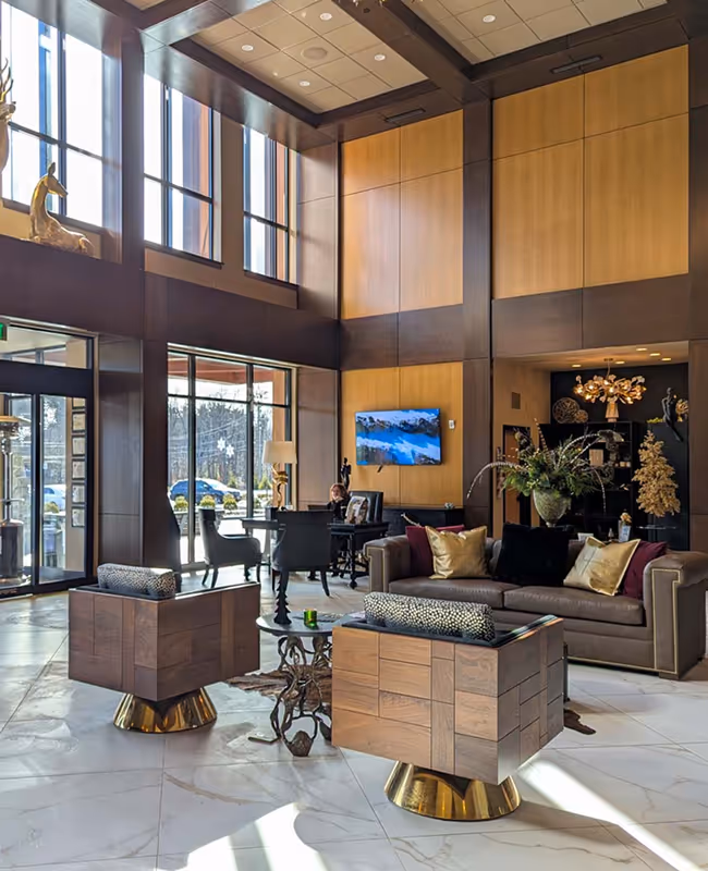 Modern luxury lobby at The Swift Water hotel featuring designer furniture and high ceilings.