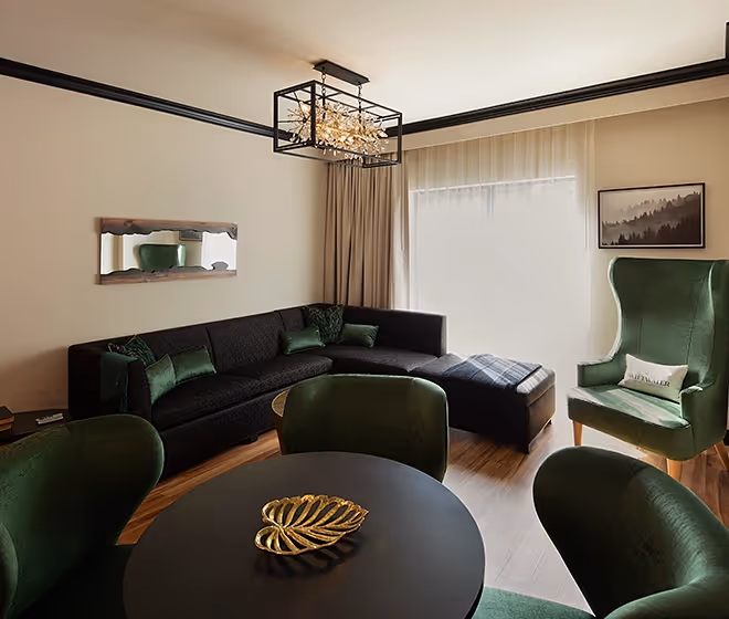 Multi-functional living space at The Swiftwater, including a sophisticated dining area and a large sectional sofa for a luxurious stay.