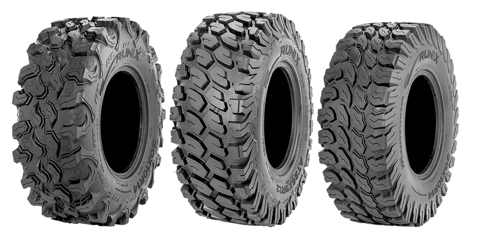 Two large off-road tires with deep tread, showing black and silver alloy wheel rim