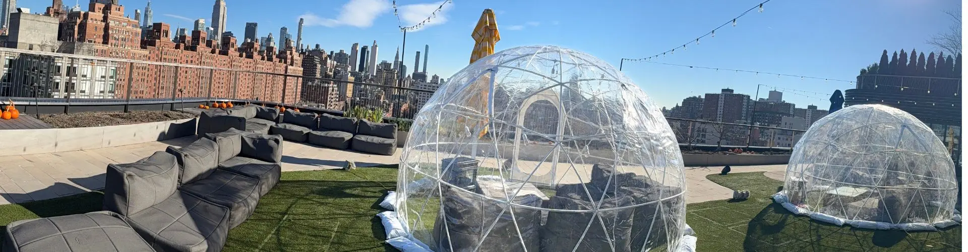 Clear igloo rentals set up on a New York City rooftop for outdoor corporate events