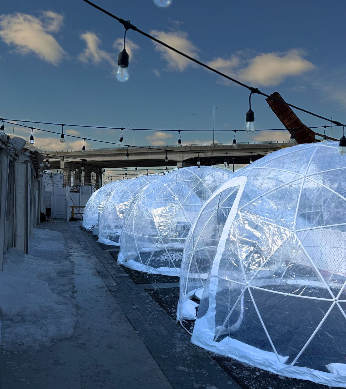 Multiple heated outdoor dining igloos installed along the waterfront at Klein’s Fish Market in Belmar New Jersey