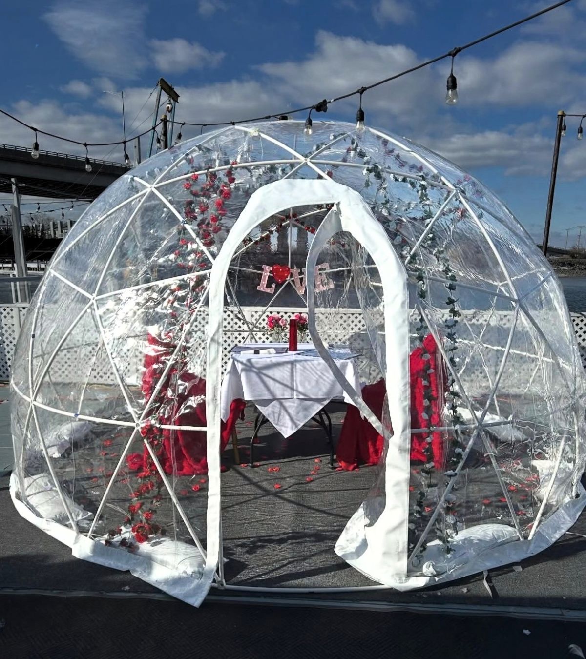 Furnished outdoor dining igloo with table seating and seasonal decor