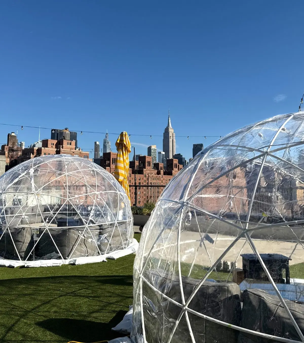 Multiple furnished igloos installed on a New York City rooftop