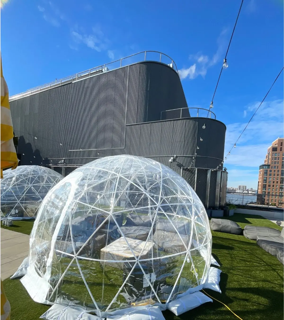 Multiple igloo rentals installed on a rooftop terrace for an outdoor event