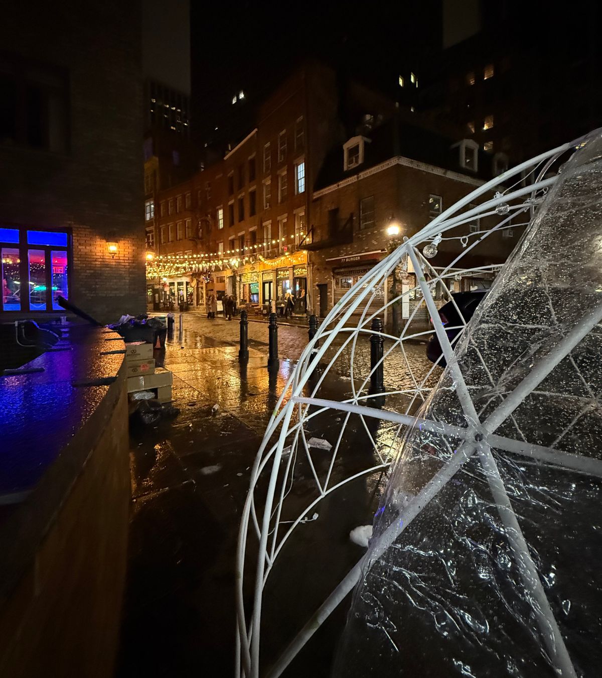 Heated event igloo illuminated at night with decorative string lights