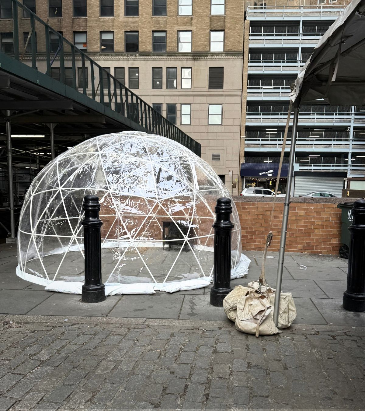Heated event igloo illuminated at night with decorative string lights