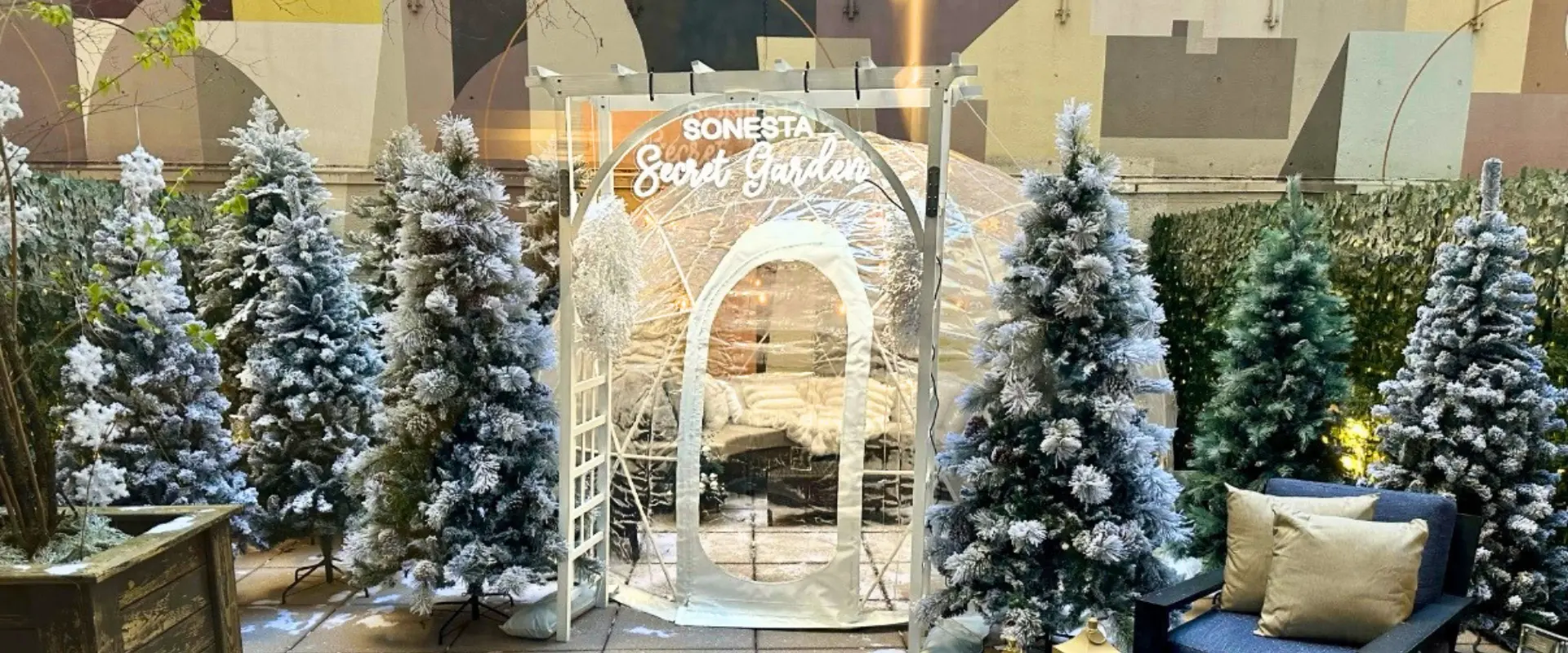 Furnished outdoor dining igloo with table seating and seasonal decor