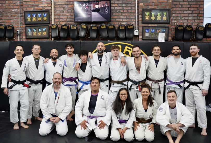 Gym members pose together at Glory Martial Arts Center's last belt promotion ceremony.