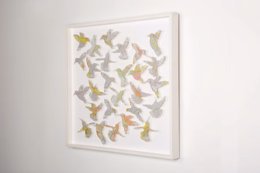 Brewster creates beautiful, intricate paper cuts of birds, flowers, and insects out of vintage paper maps.
