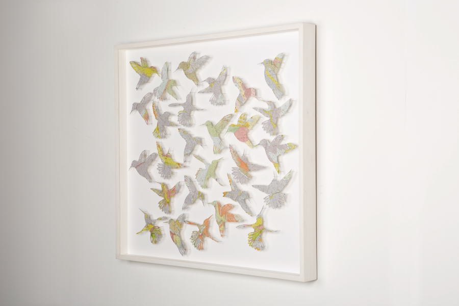 Brewster creates beautiful, intricate paper cuts of birds, flowers, and insects out of vintage paper maps.