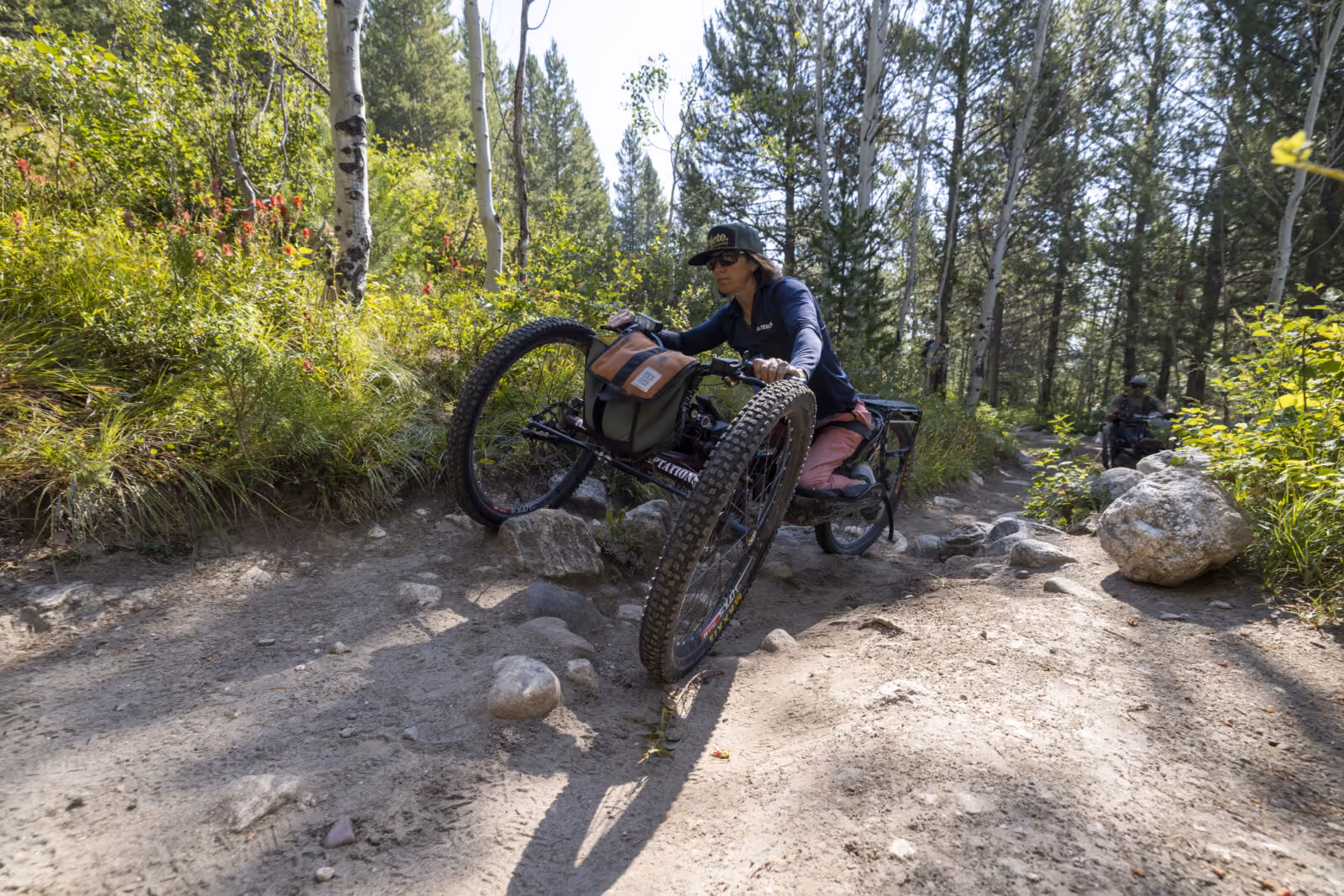 Quinn Brett maneuvers through a rocky trail. Improvements to this popular route could make it easier and safer for visitors with disabilities to navigate.
