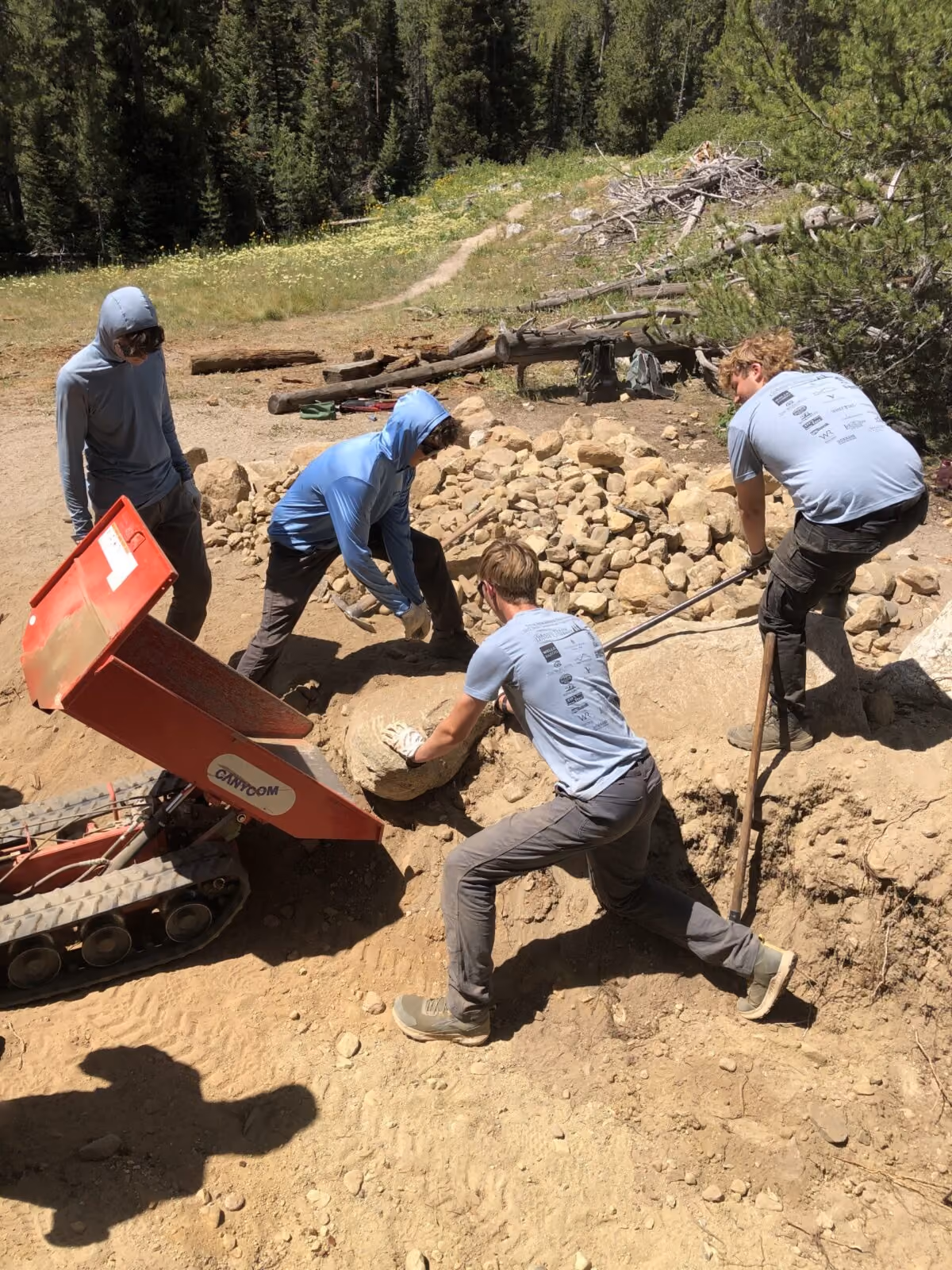 YCP crew members work together to move large rocks at the Leigh Lake portage.