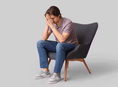 Man sitting at a desk looking fatigued and low in energy during the day