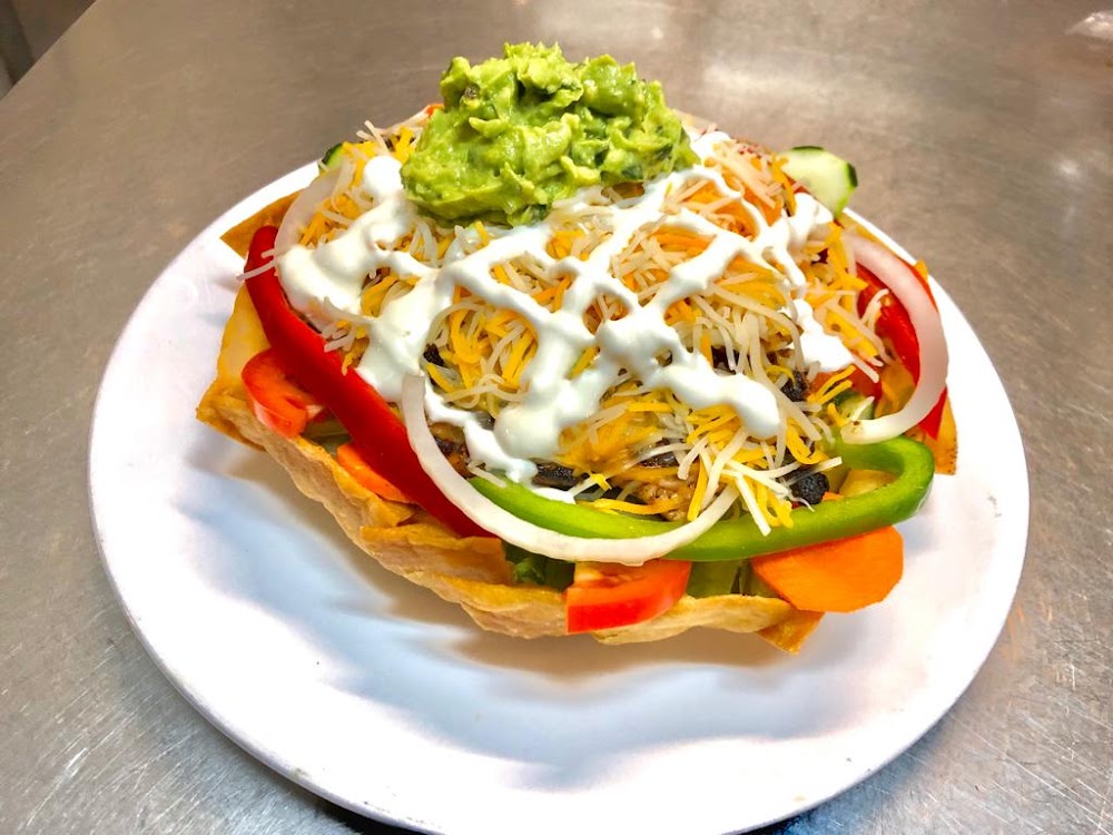 A plate of food with a white plate and a white sauce.