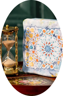 Gold hourglass next to a decorative tile with a colorful geometric star pattern.