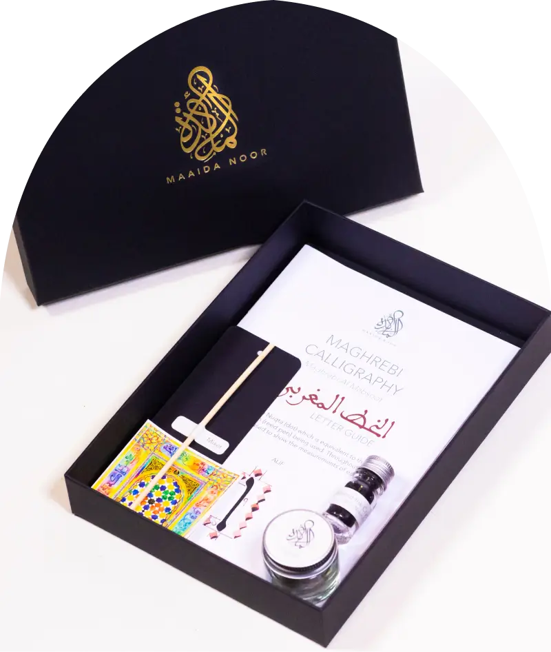 Black calligraphy kit box with gold Maaida Noor logo, containing a Maghrebi Calligraphy letter guide, ink pots, and a calligraphy pen.