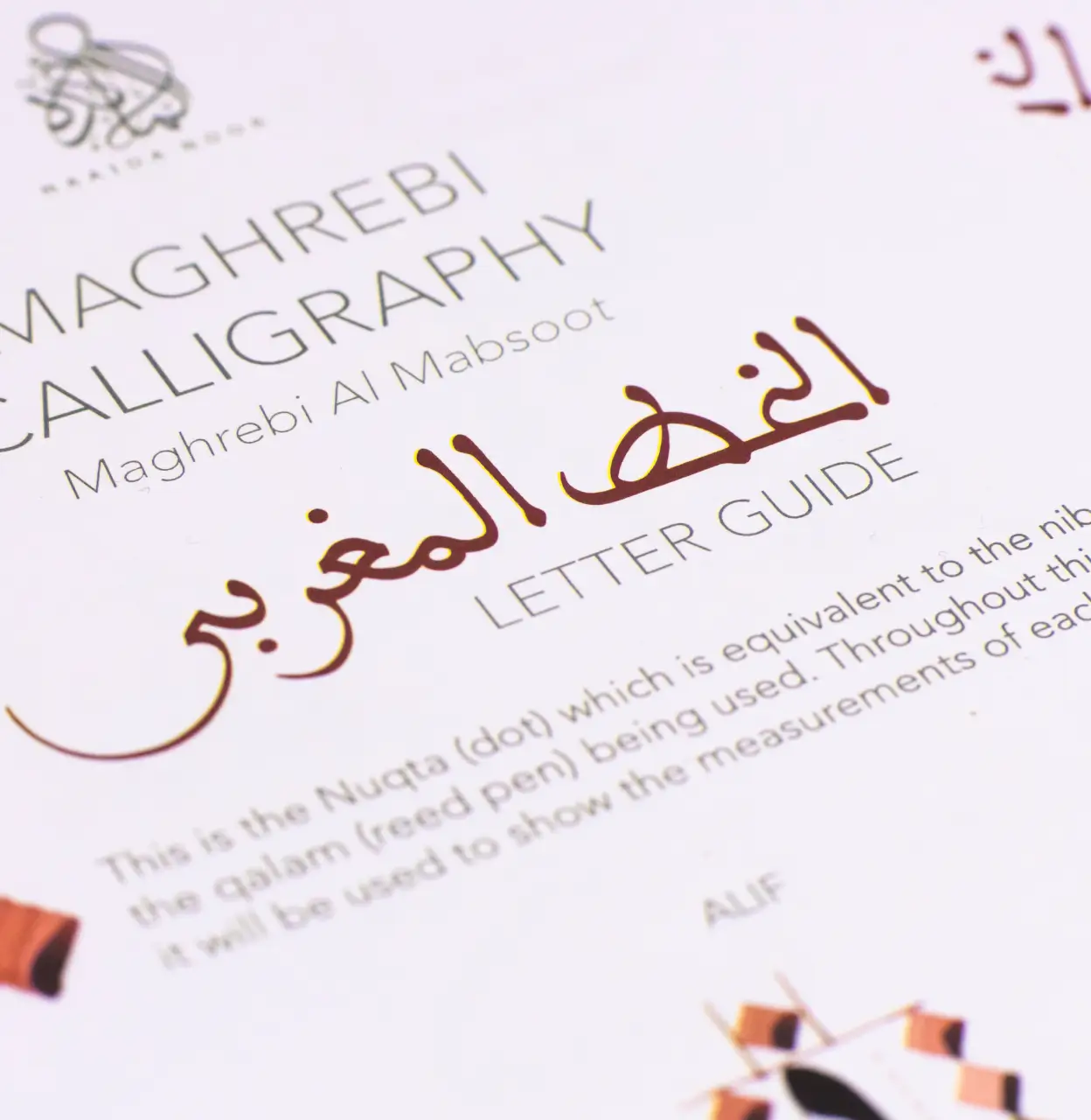 Close-up of a Maghrebi Calligraphy letter guide page featuring Arabic script and English text explaining the Nuqta dot and qalam reed pen.