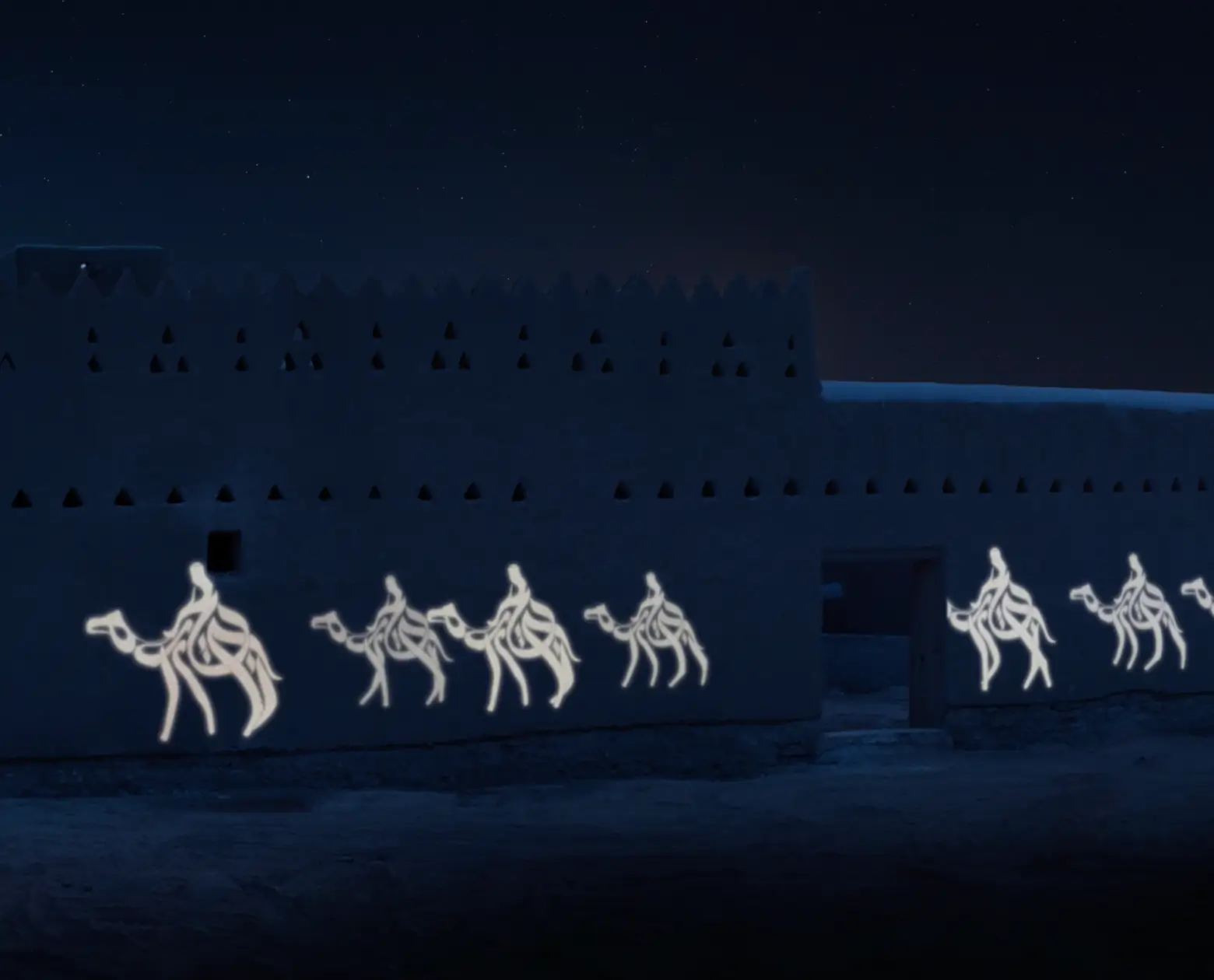 Illuminated neon light art of camel riders on the exterior wall of a dark traditional building at night.