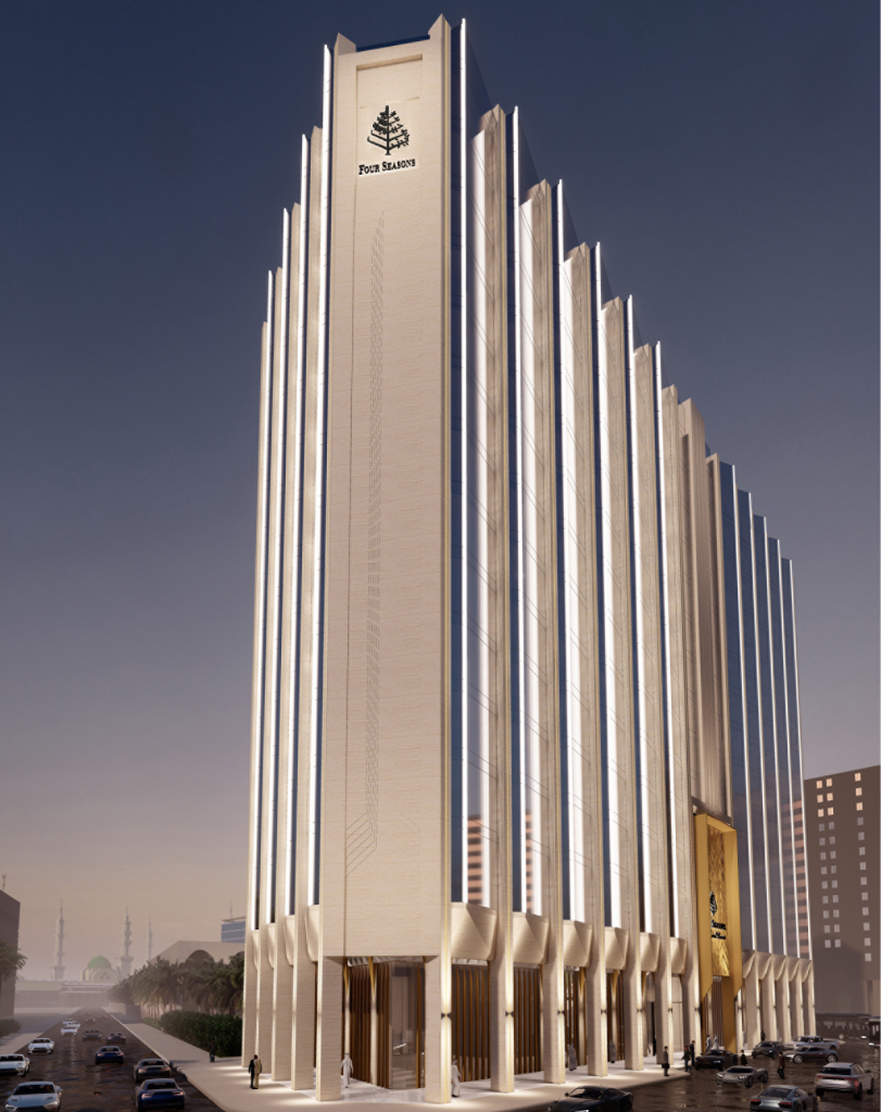 An exterior view of a striking modern skyscraper with vertical white fins and a sleek, tiered architectural design.