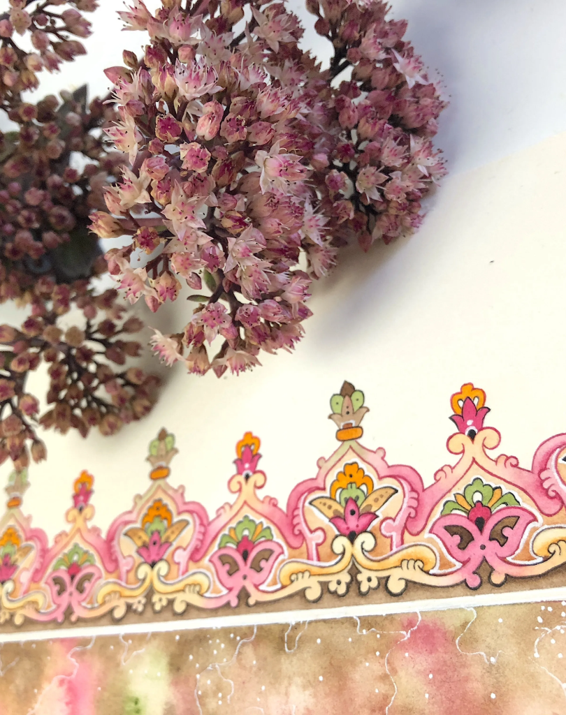 A close-up lifestyle shot featuring the pink floral and geometric patterns of the Mirzam packaging alongside dried purple flowers.