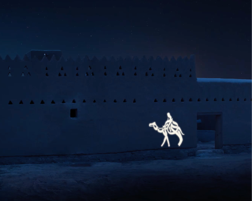 A minimalist white light projection of a single person riding a camel, centered on a dark stone architectural wall.