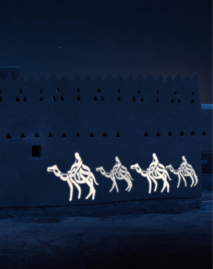A glowing white projection of a camel caravan with multiple riders moving across the textured surface of a dark, historic building.