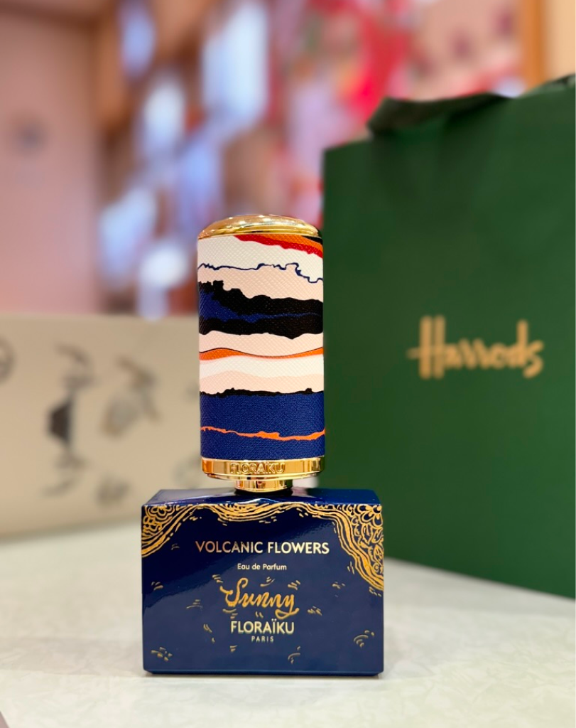 Floraïku Volcanic Flowers fragrance bottle displayed in front of a green Harrods gift bag.