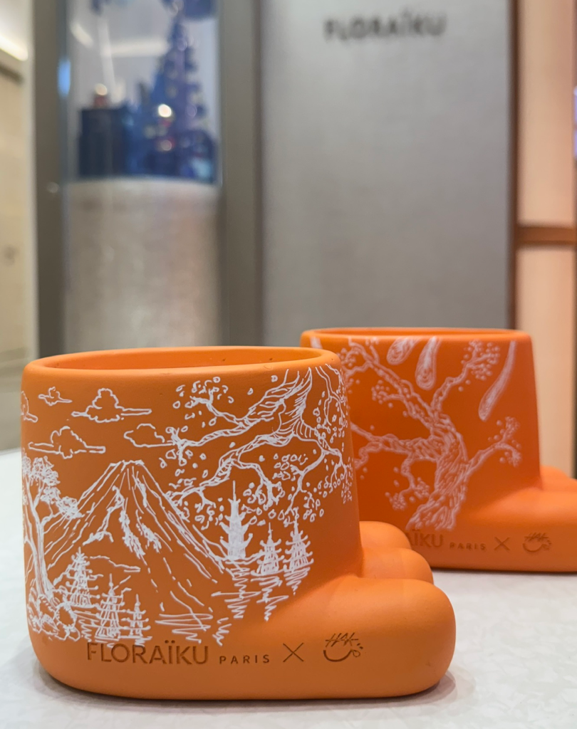 Orange Floraïku candle holders with white illustrations of Mount Fuji and Japanese pagodas.