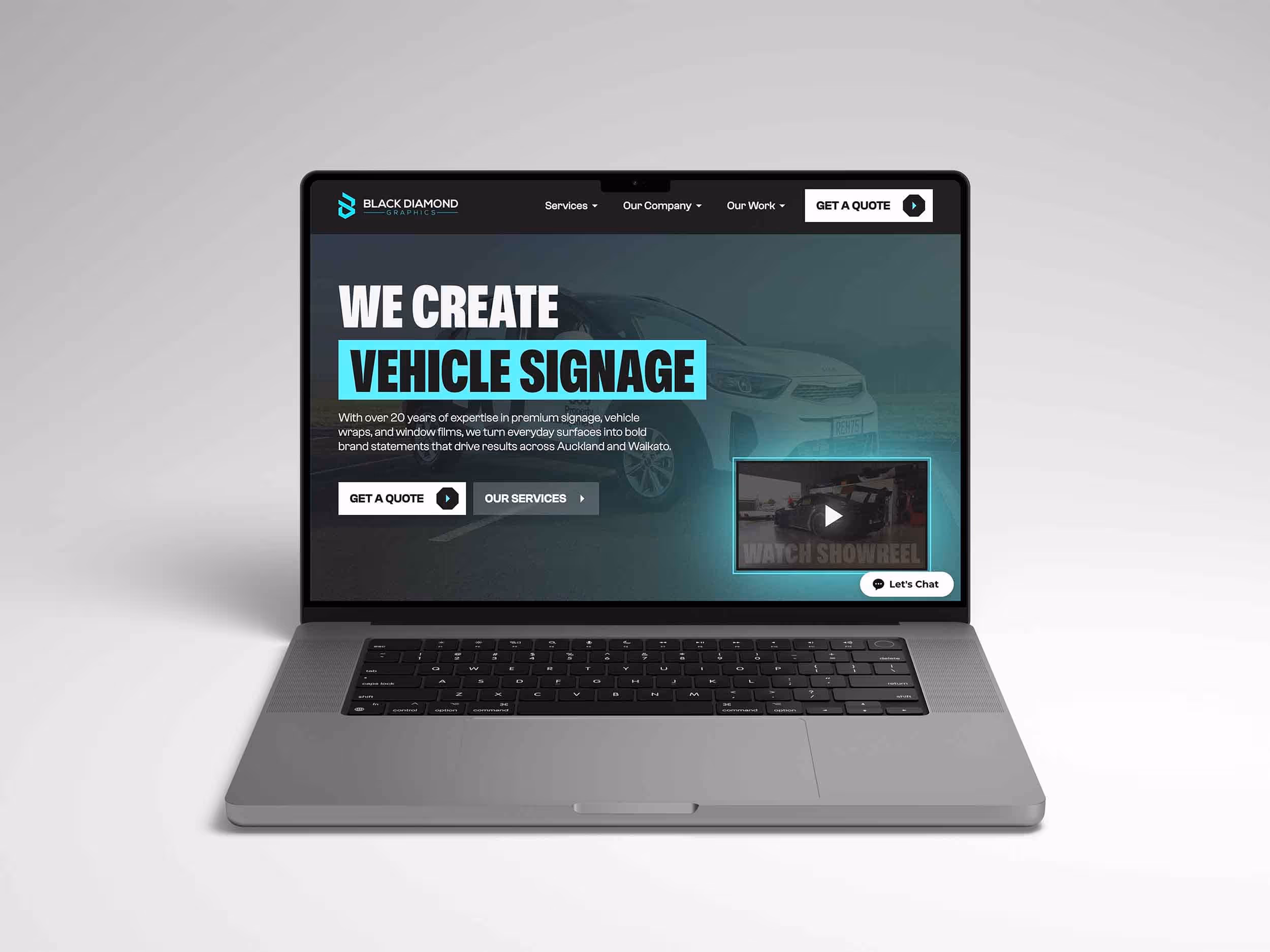 Laptop displaying Black Diamond Graphics website homepage featuring vehicle signage services and call-to-action buttons.