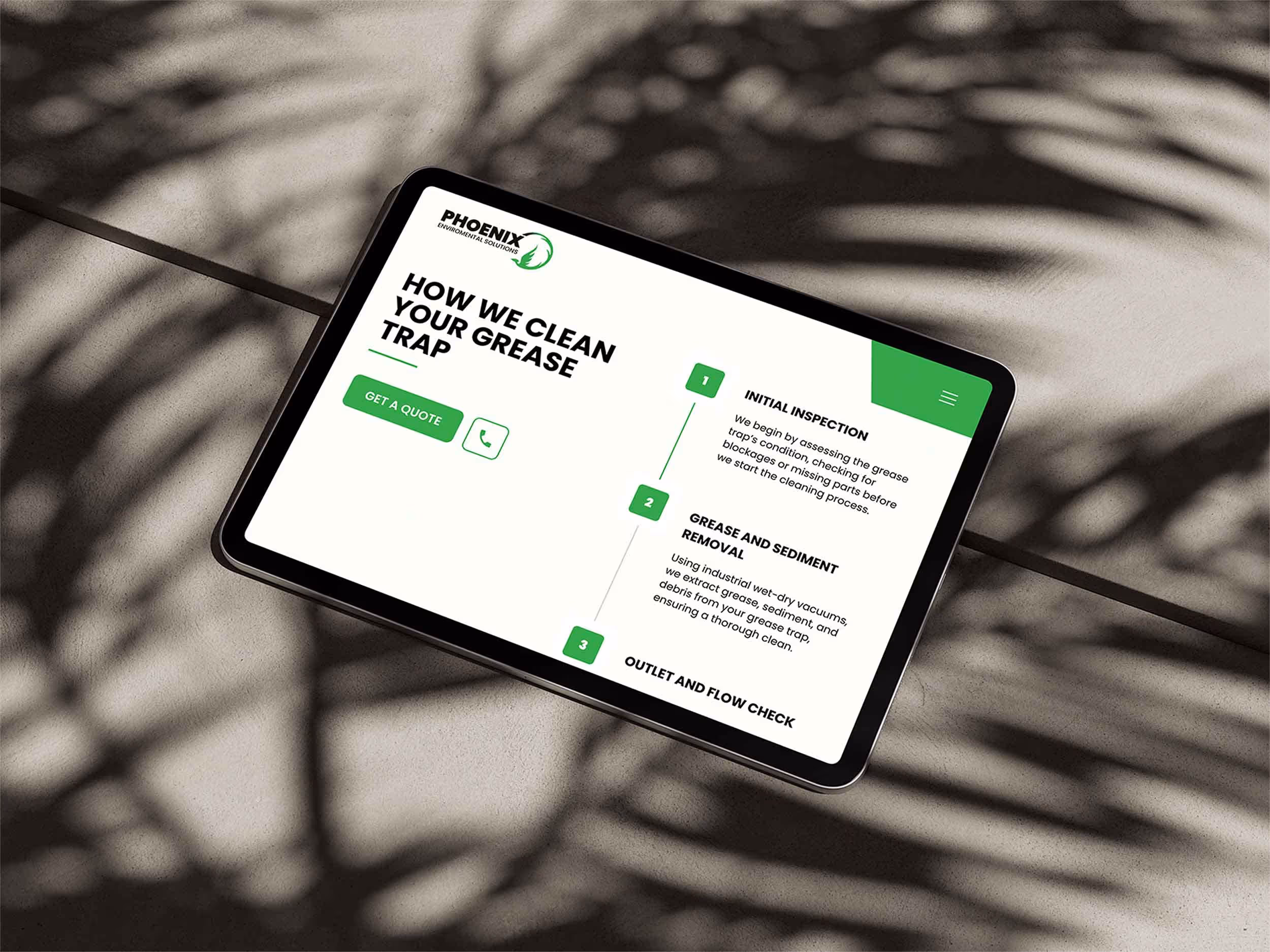 Tablet displaying Phoenix Environmental Solutions website page on cleaning grease traps, showing steps for initial inspection, grease removal, and outlet check.