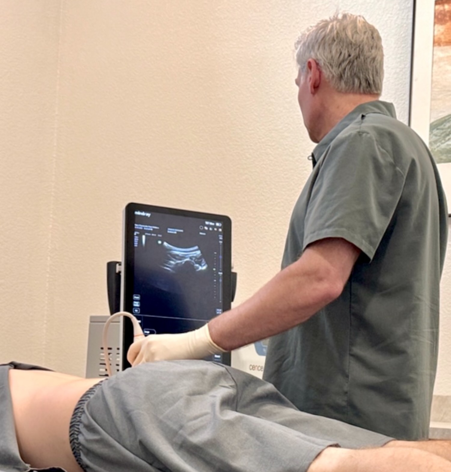 Physician performing ultrasound-guided spine evaluation at Alypos Regenerative Pain and Wellness in Southlake, Texas