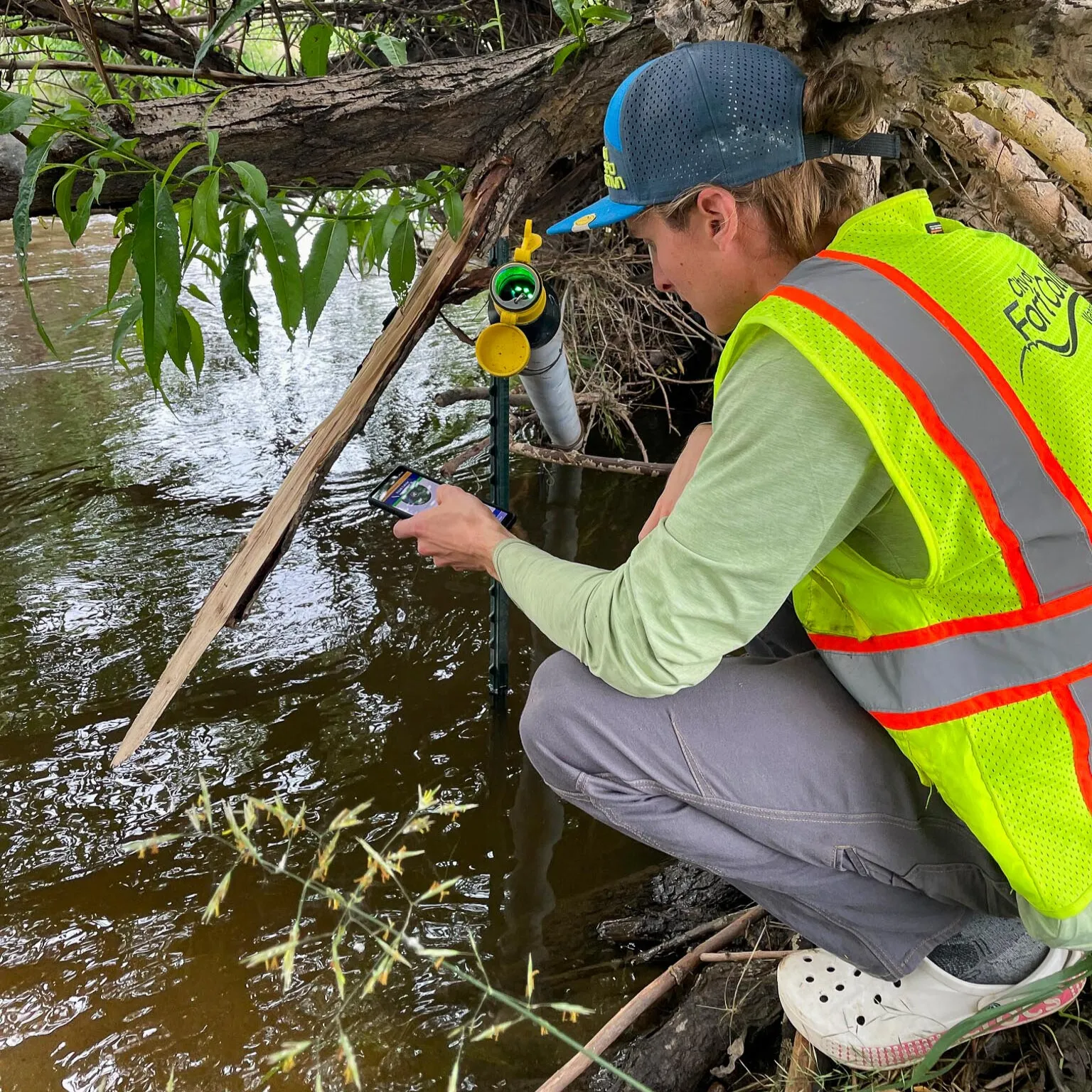 Sam Struthers calibrates In-Situ water quality sensor on the Poudre River