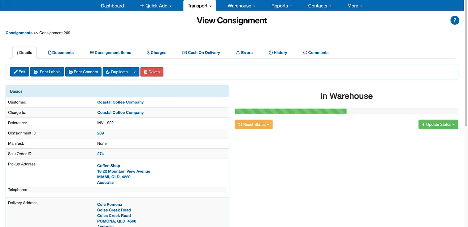 Web dashboard displaying consignment details including customer Coastal Coffee Company, pickup and delivery addresses, with status bar labeled In Warehouse and options to reset or update status.
