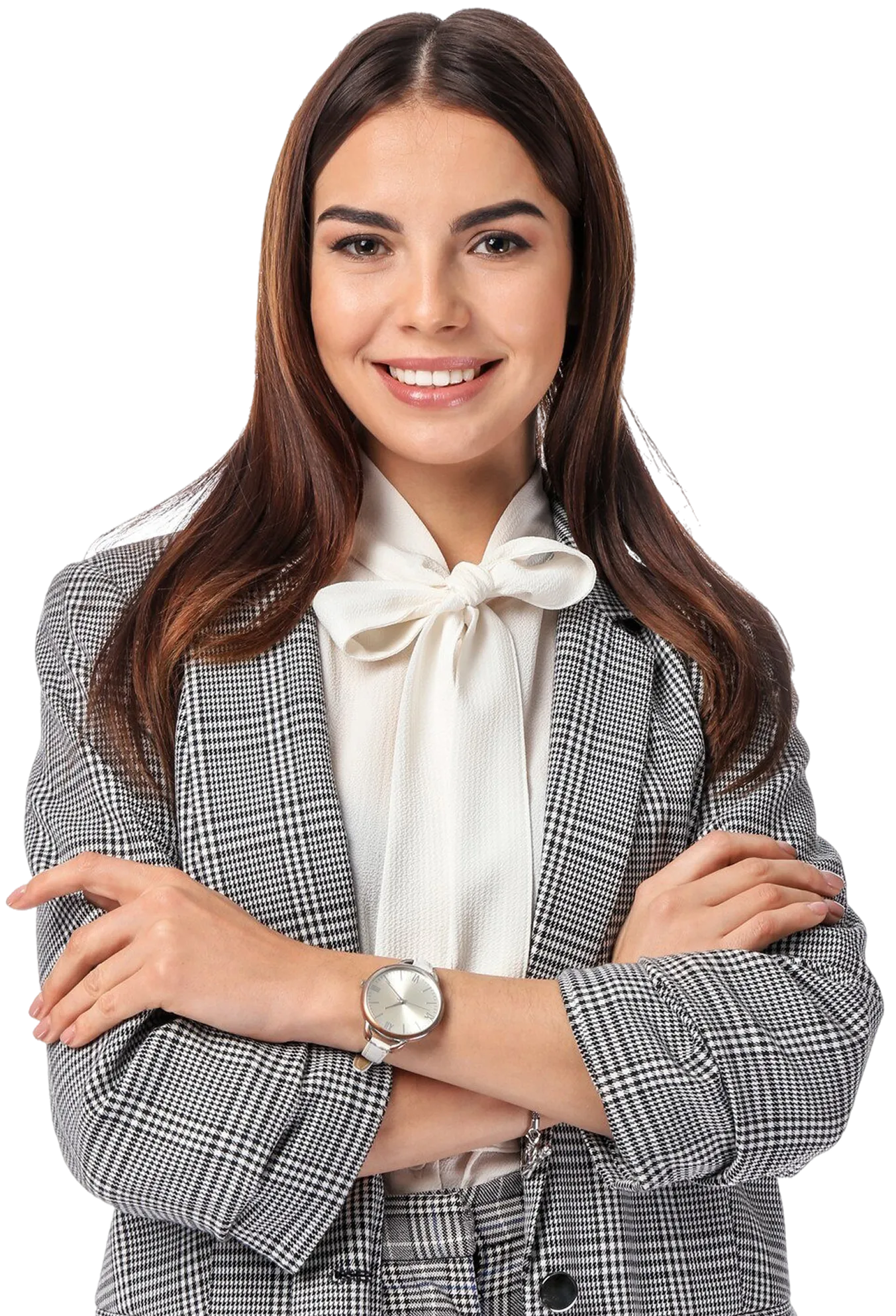 Smiling woman with long brown hair wearing a black and white checkered blazer and matching pants with a white blouse and wristwatch, arms crossed.